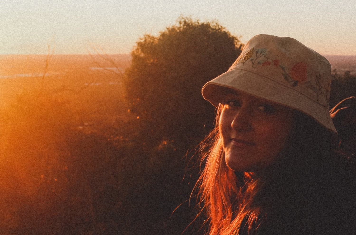 Australian natives hemp bucket hat on brunette model overlooking sunset